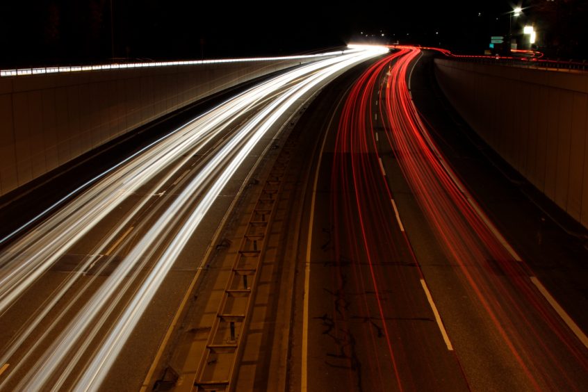 long exposure image of cars driving at night