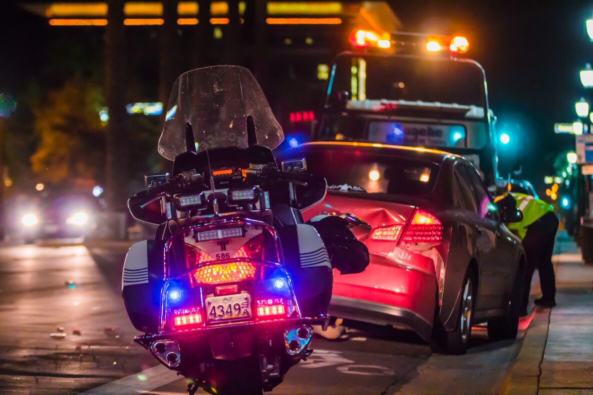 police motorcycle at night attending scene of an accident